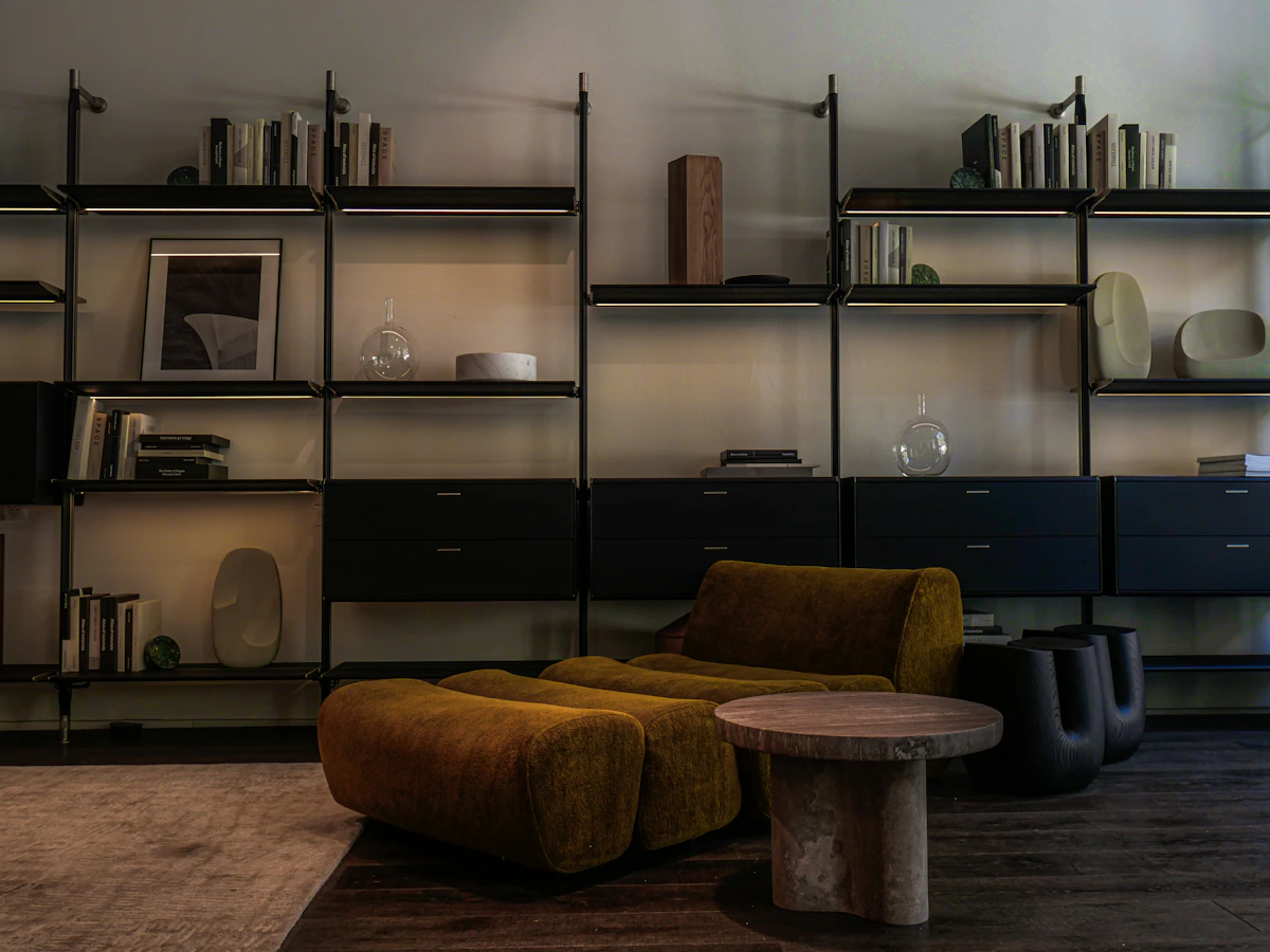 Small living room with modular shelving and a compact armchair