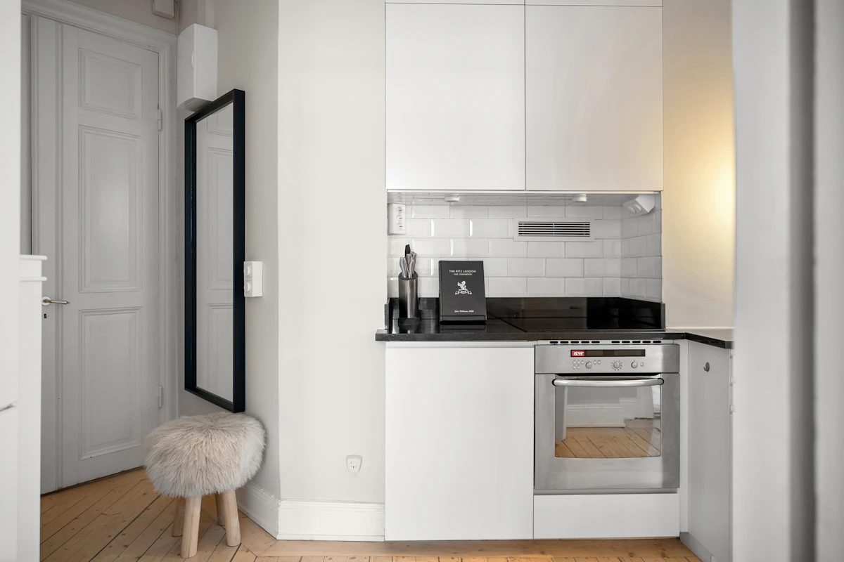 Small kitchen with compact cabinetry and a clear work surface