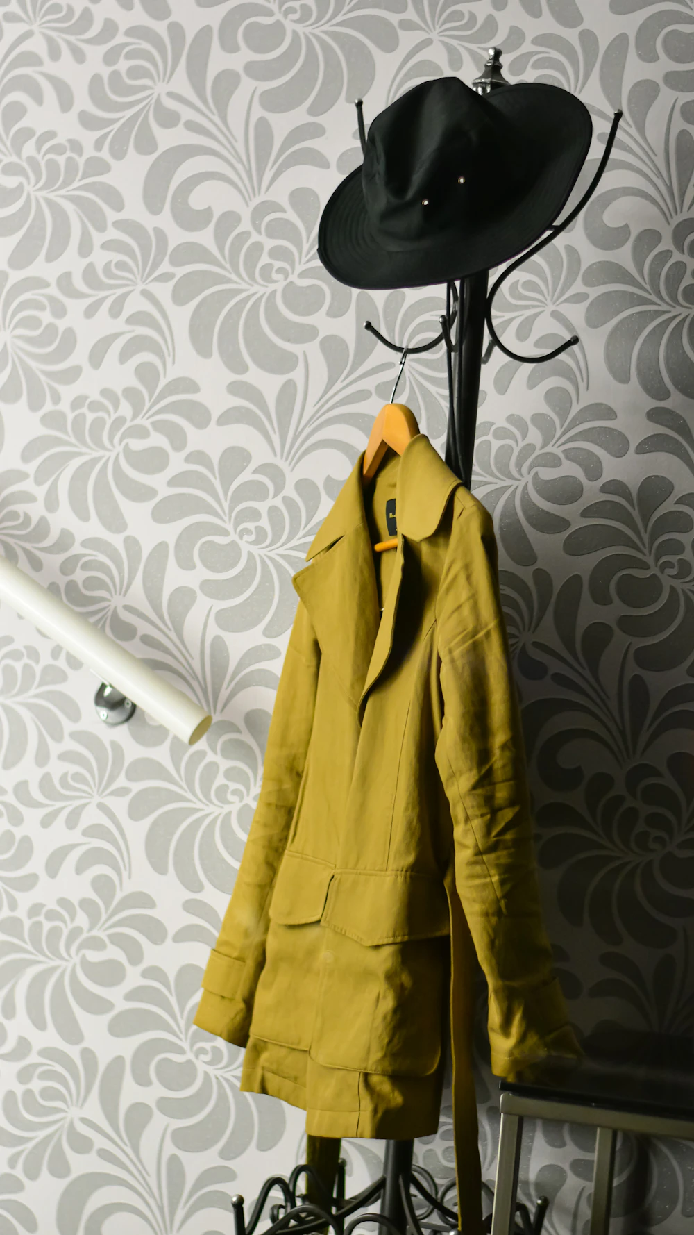 Coat and hat hanging on a compact entryway rack
