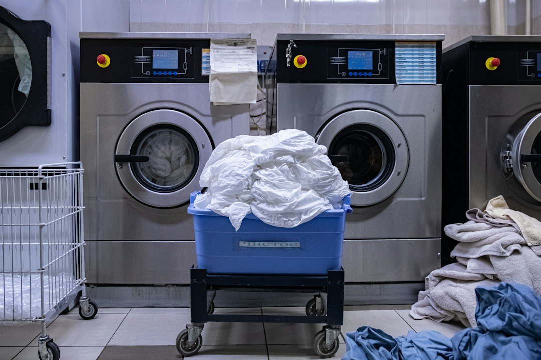 Laundry room with a washing machine and portable laundry basket