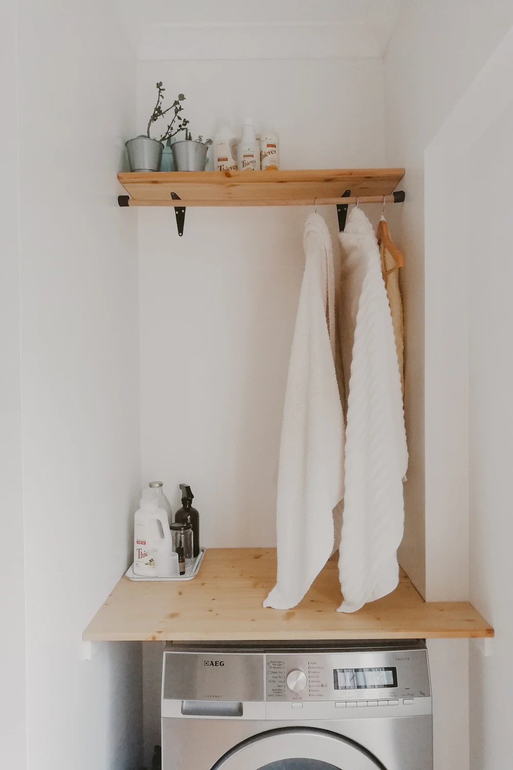 Compact laundry nook with organized storage above the machines