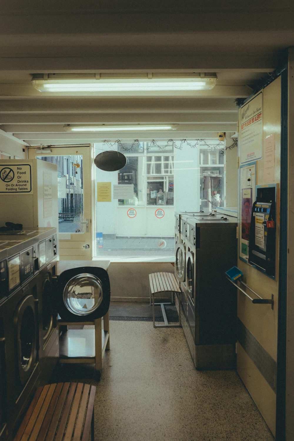 Narrow laundry room with a washer, dryer and vertical storage