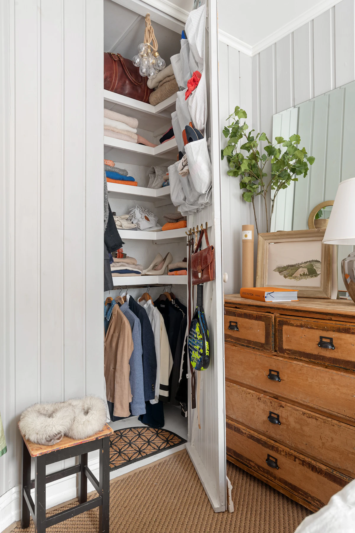 Compact bedroom with a bed, closet and narrow wood dresser