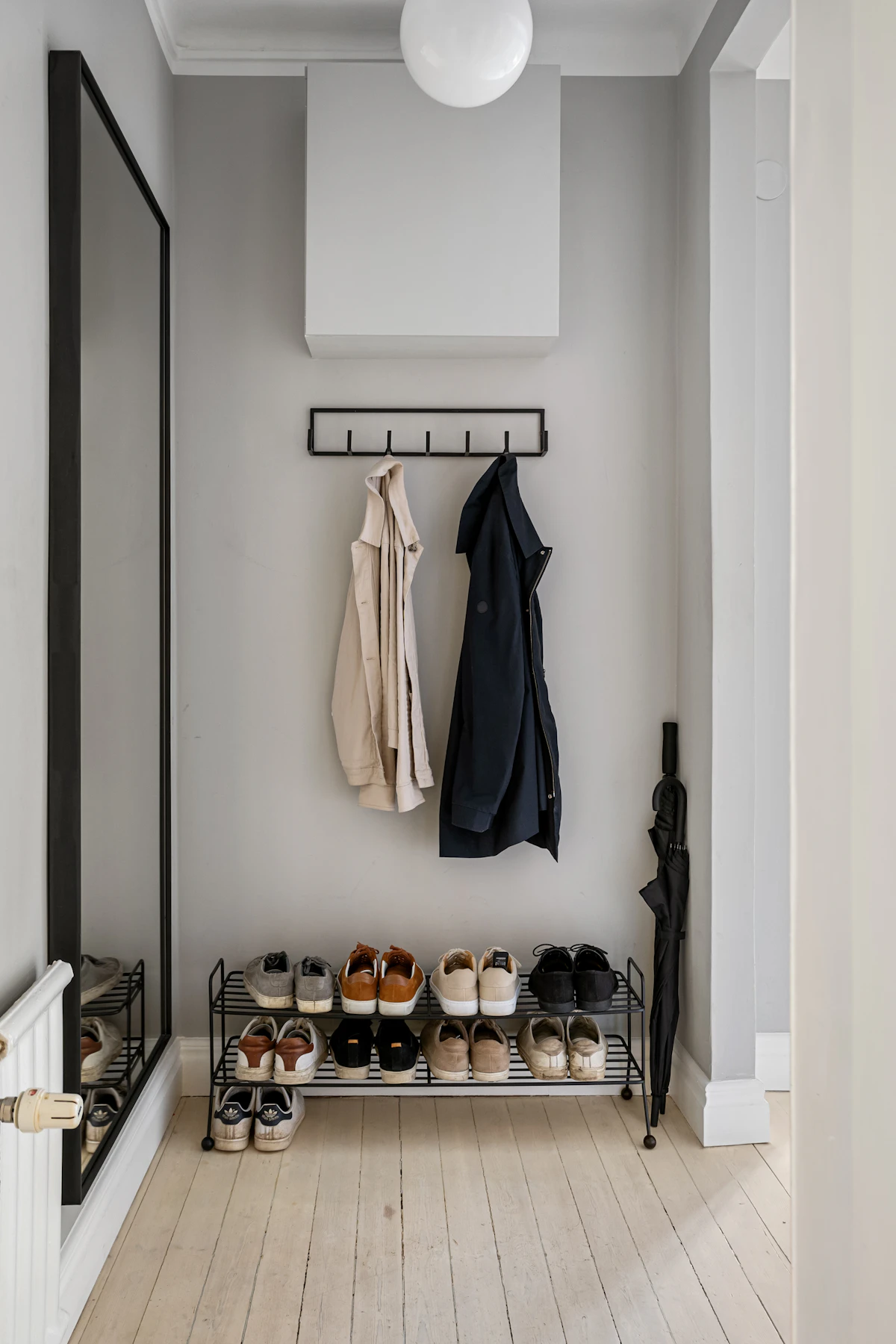 Apartment hallway with a coat rack and shoes near the entrance