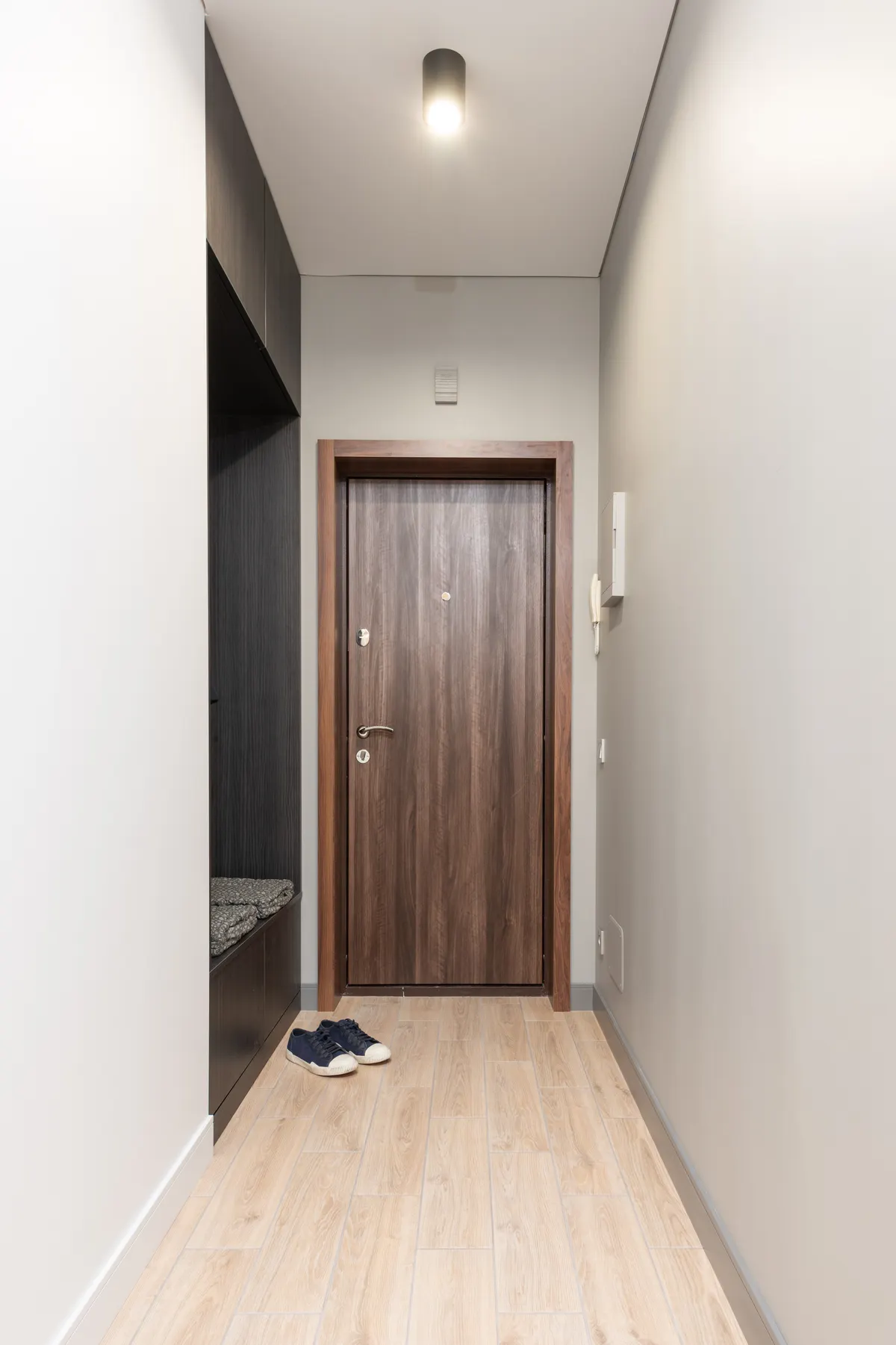 Small apartment shoe storage ideas using a compact wardrobe beside the entry door
