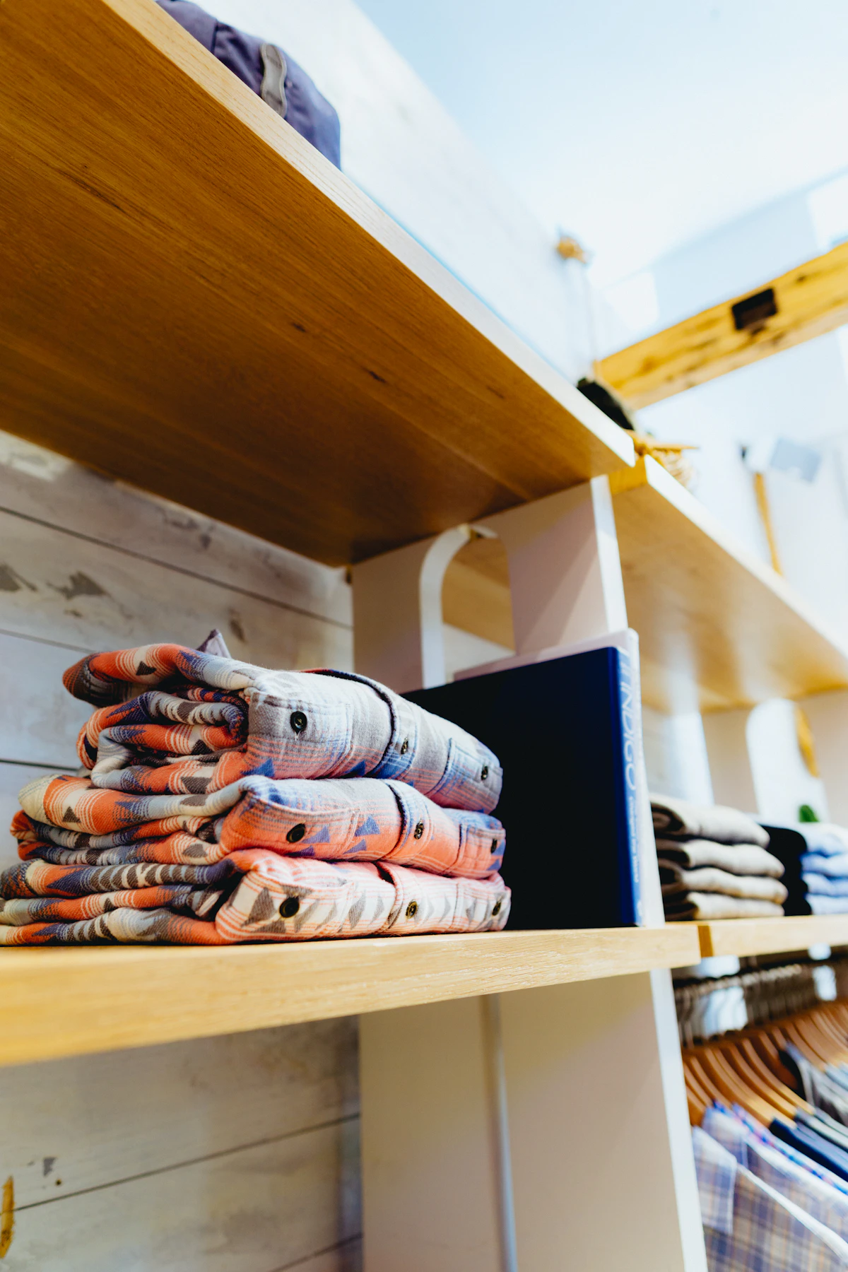 Neatly folded shorts arranged on a shallow shelf