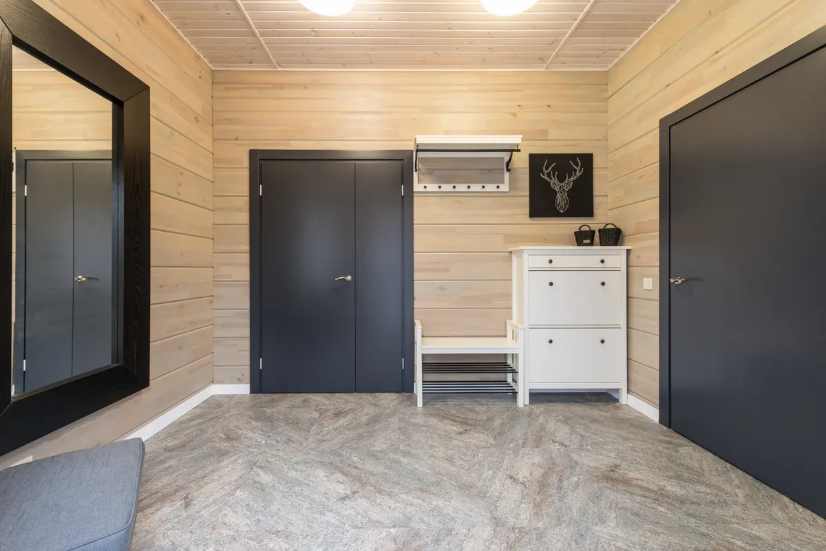 Narrow apartment hallway with a compact cabinet and wall mirror
