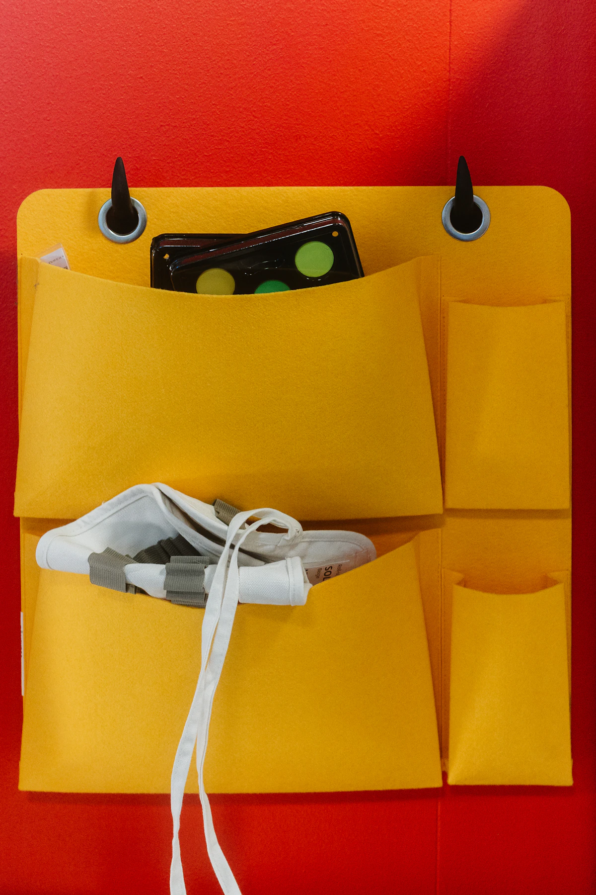 Fabric pocket organizer holding shoes and small accessories