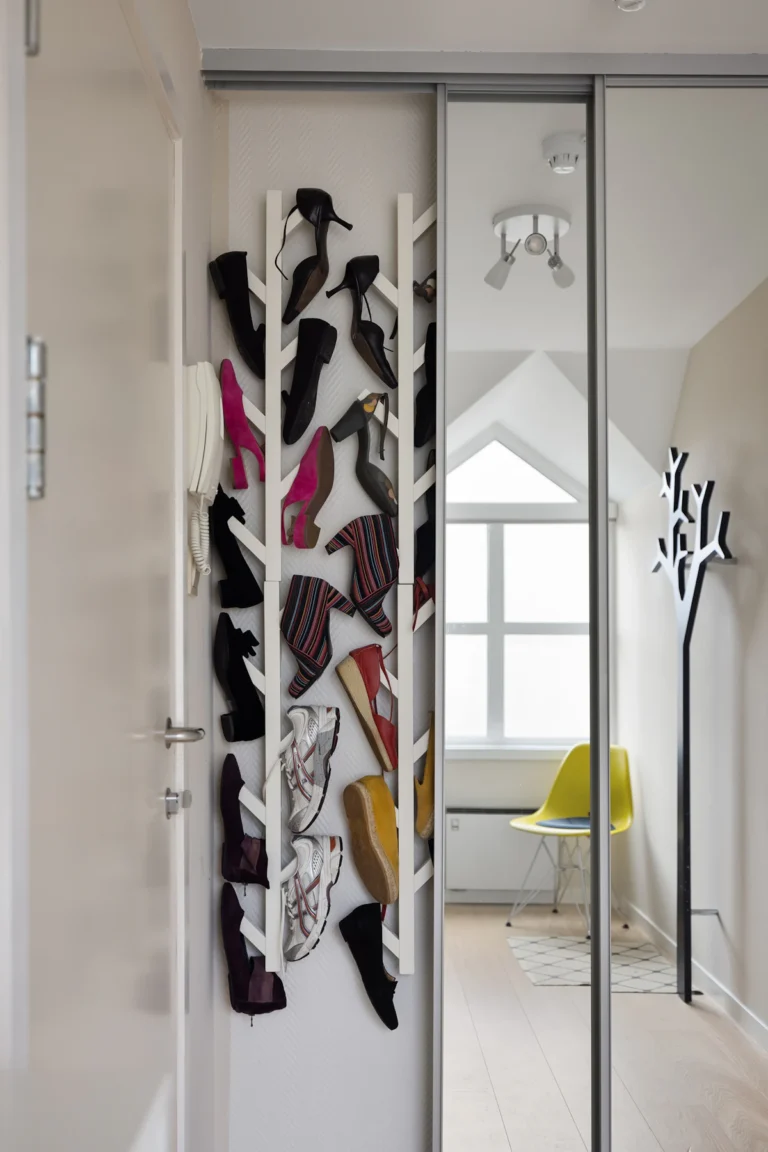 Door-mounted rack holding shoes on the back of a bedroom door