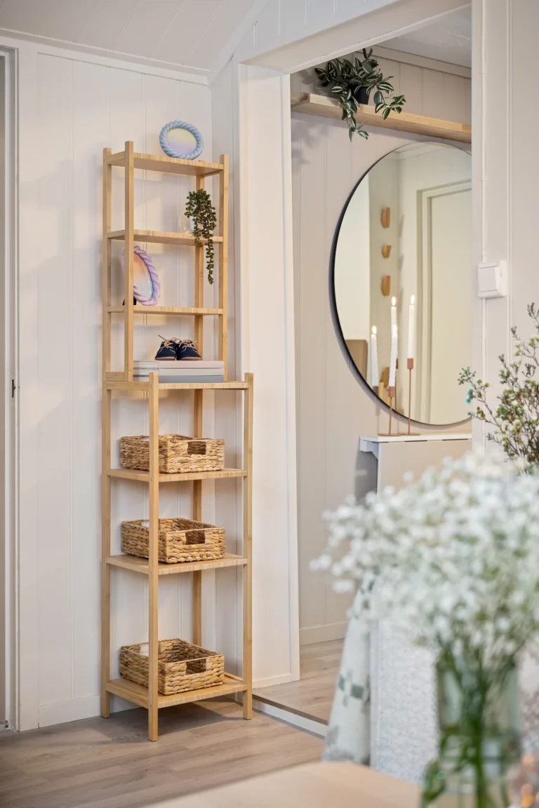 Slim shelving with baskets and a mirror in a compact home