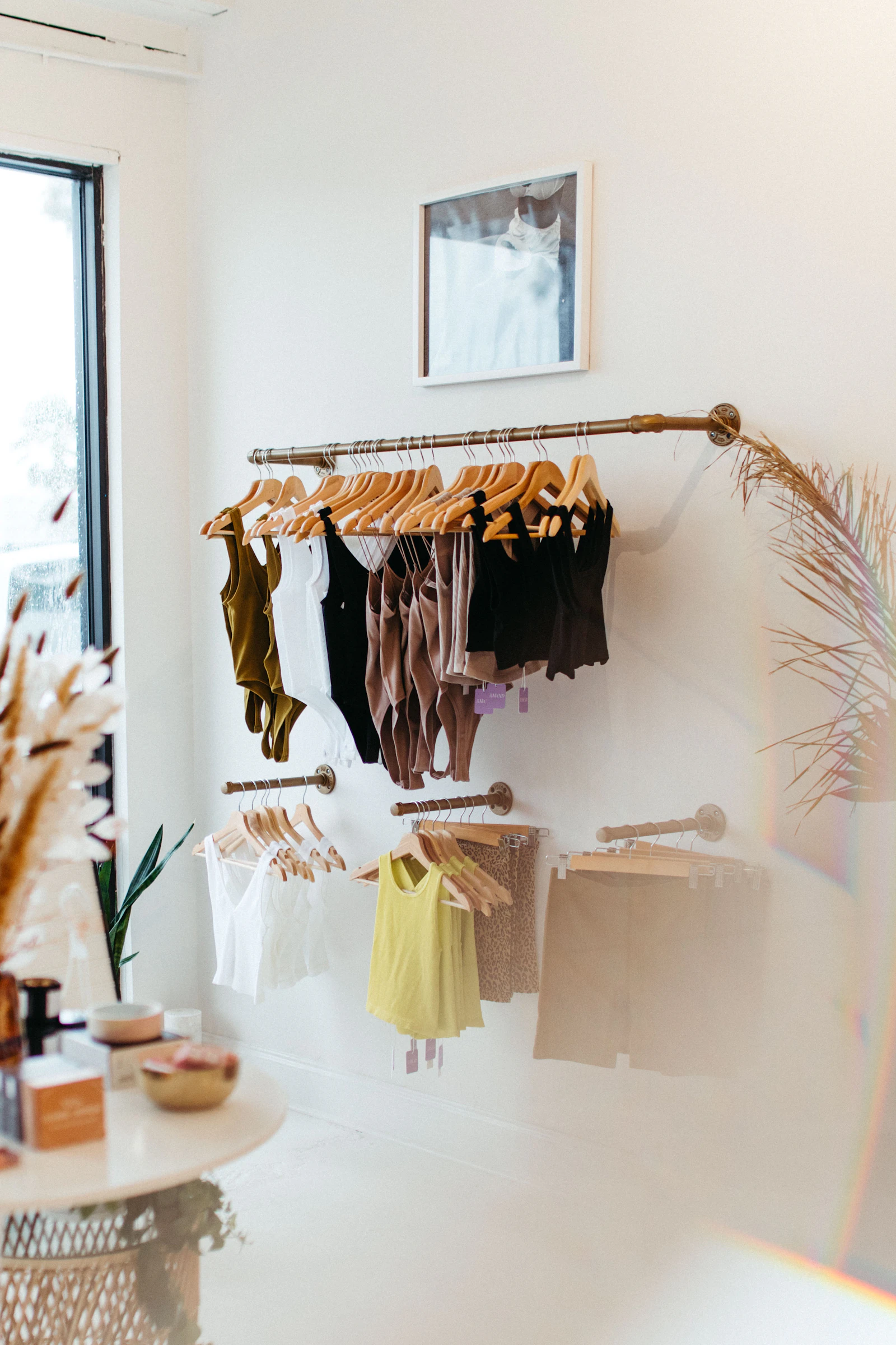 Compact bedroom clothing storage using wall-mounted garment rails